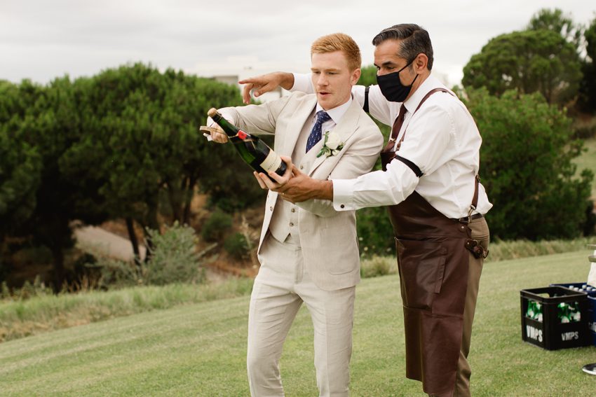 groom opening champagne