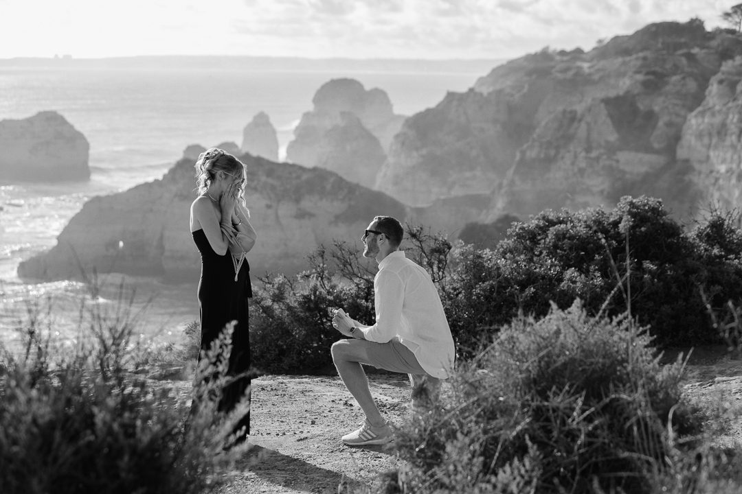 Surprise engagement proposal on the Algarve cliffs with dramatic Atlantic Ocean views, Portugal 