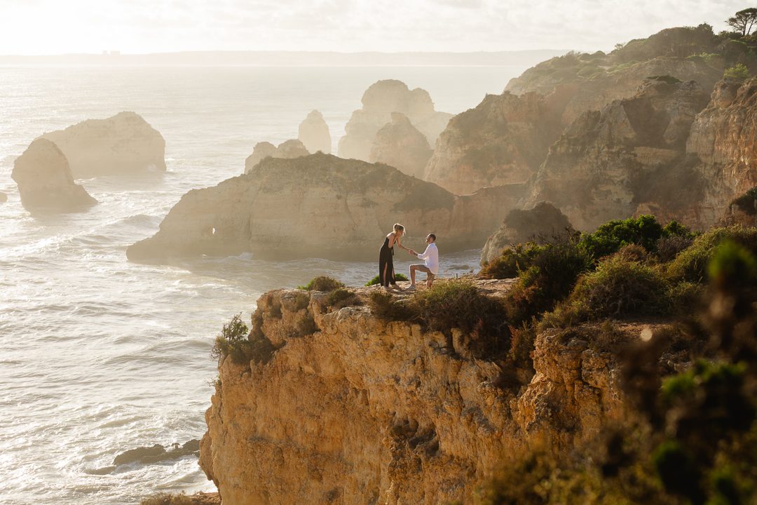 Surprise engagement proposal on the Algarve cliffs with dramatic Atlantic Ocean views, Portugal 