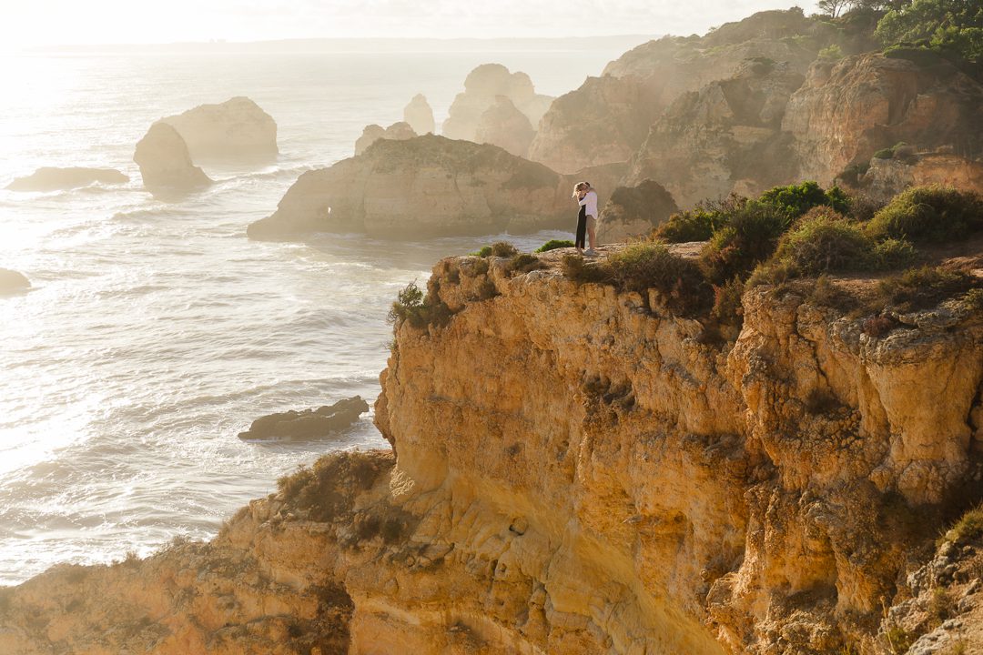 Man proposing on the cliffs of the Algarve during an autumn engagement session in Portugal 