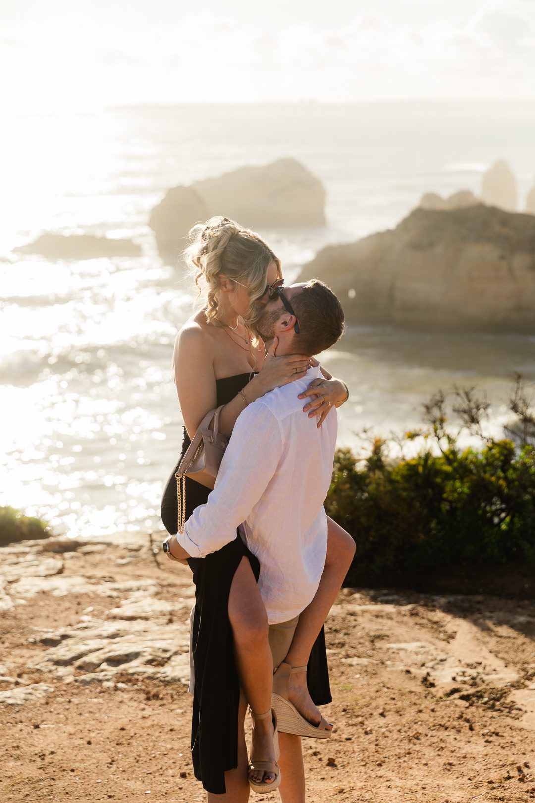 Epic cliffside engagement proposal with rough ocean waves in the Algarve, Portugal 