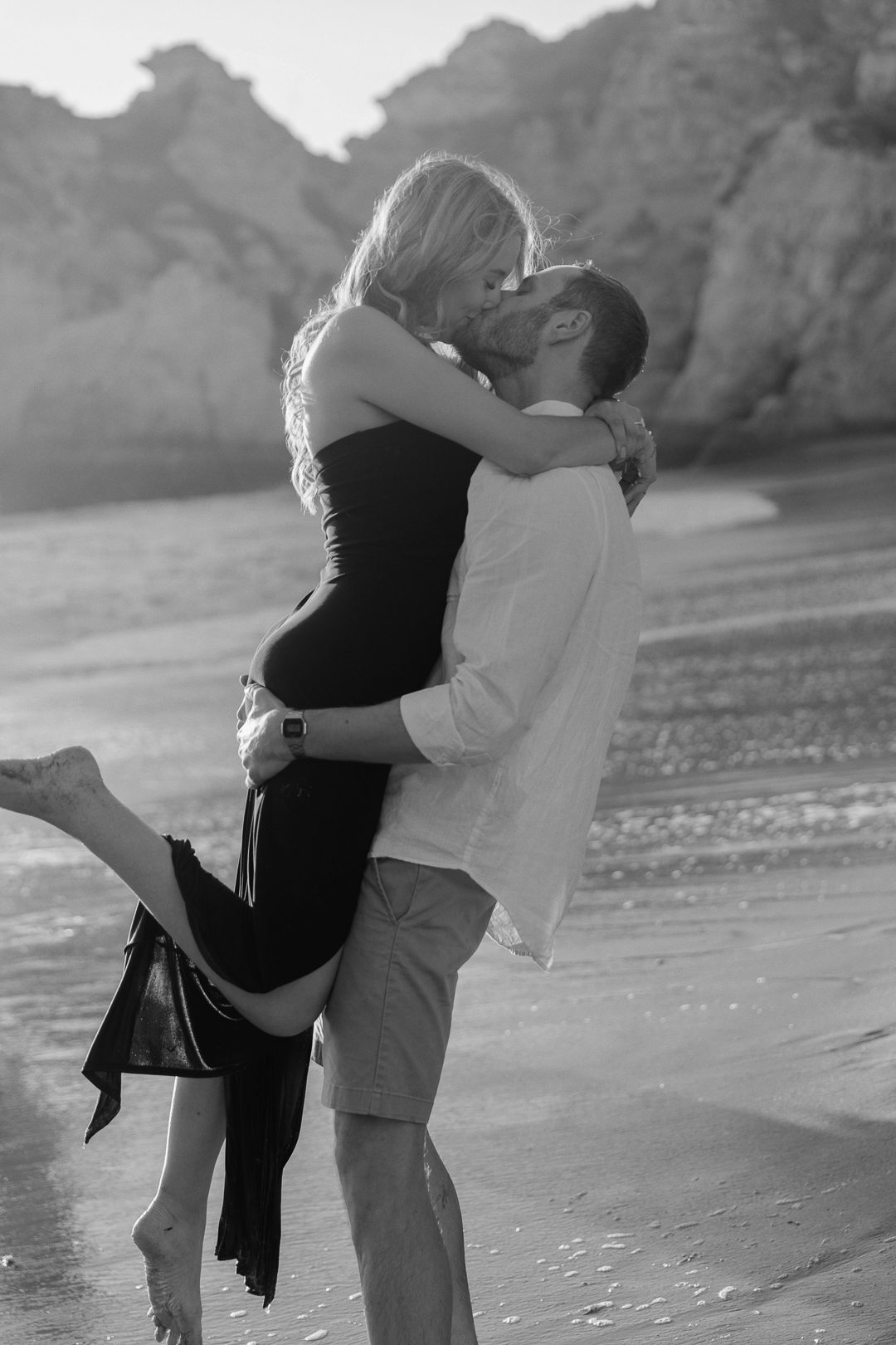 Playful beach engagement session in the Algarve after a surprise proposal 