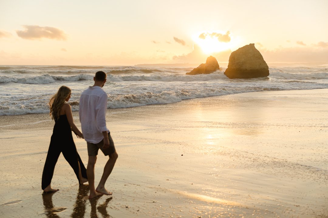 Couple sharing a quiet moment on the beach during a destination engagement shoot 