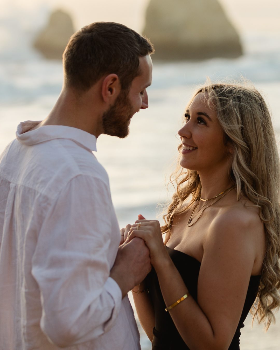 Couple sharing a quiet moment on the beach during a destination engagement shoot 