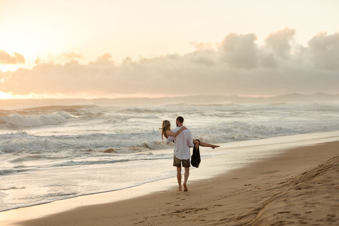 Couple sharing a quiet moment on the beach during a destination engagement shoot 