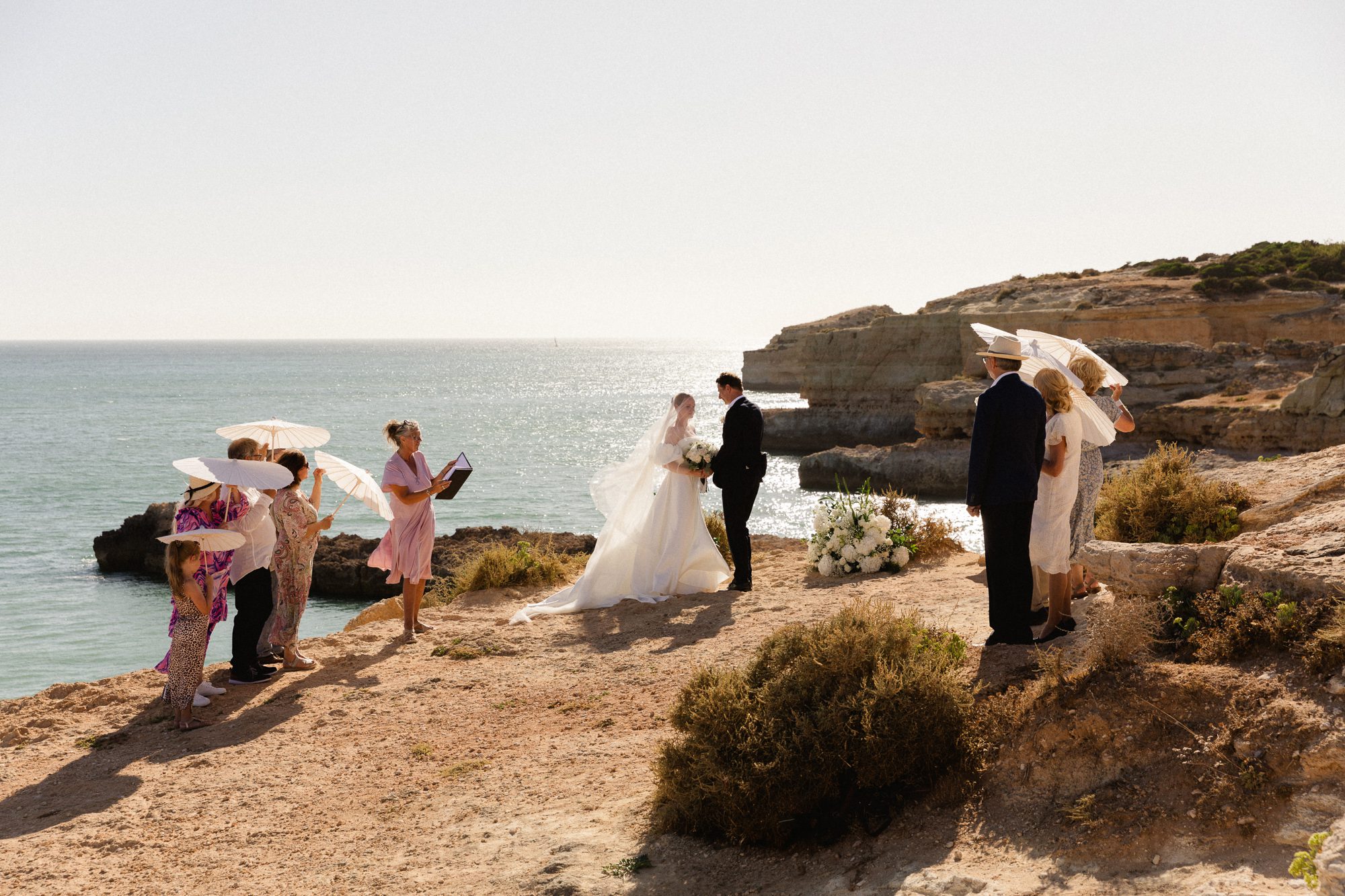 Bride wearing an elegant romantic dress and long vail in the Algarve

