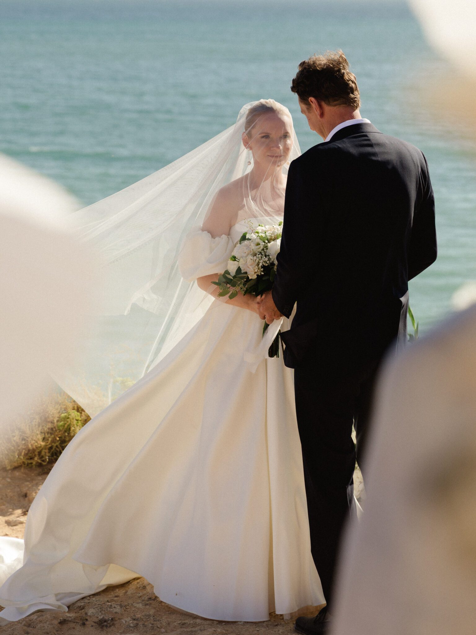 Bride and groom during an intimate clifftop ceremony in the Algarve, Portugal
