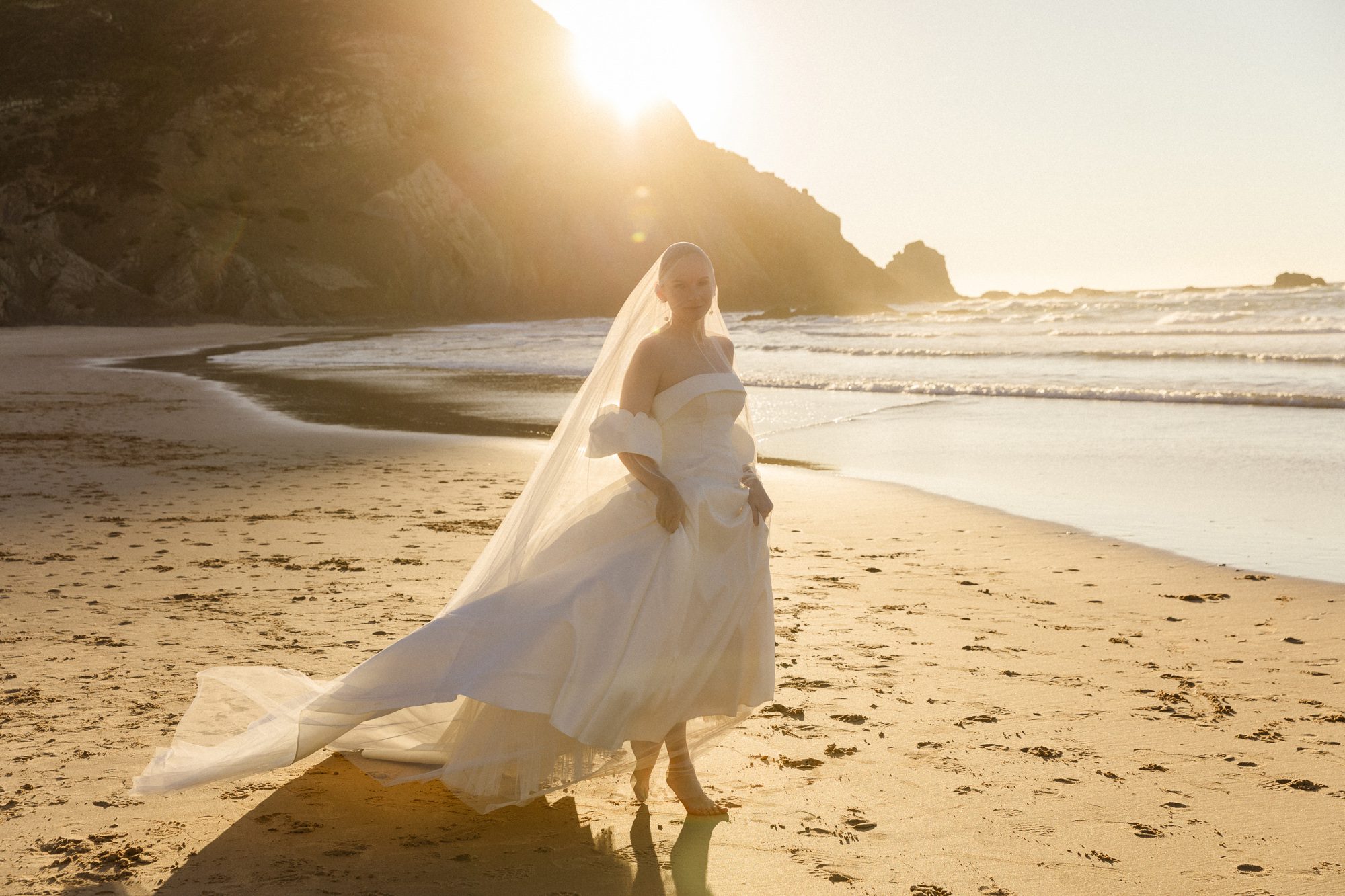 Bride wearing an elegant romantic dress and long vail in the Algarve
