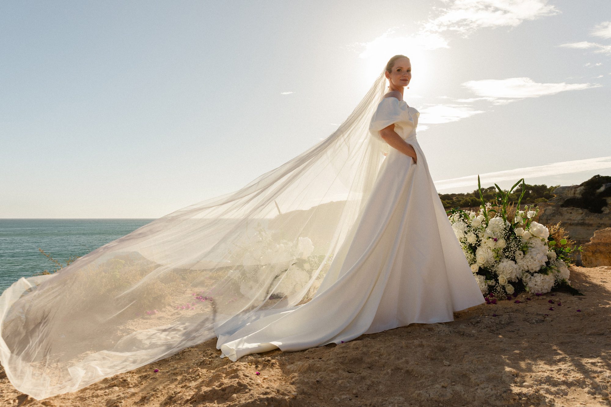 Bride in a romantic wedding gown and vail during an Algarve elopement ceremony
